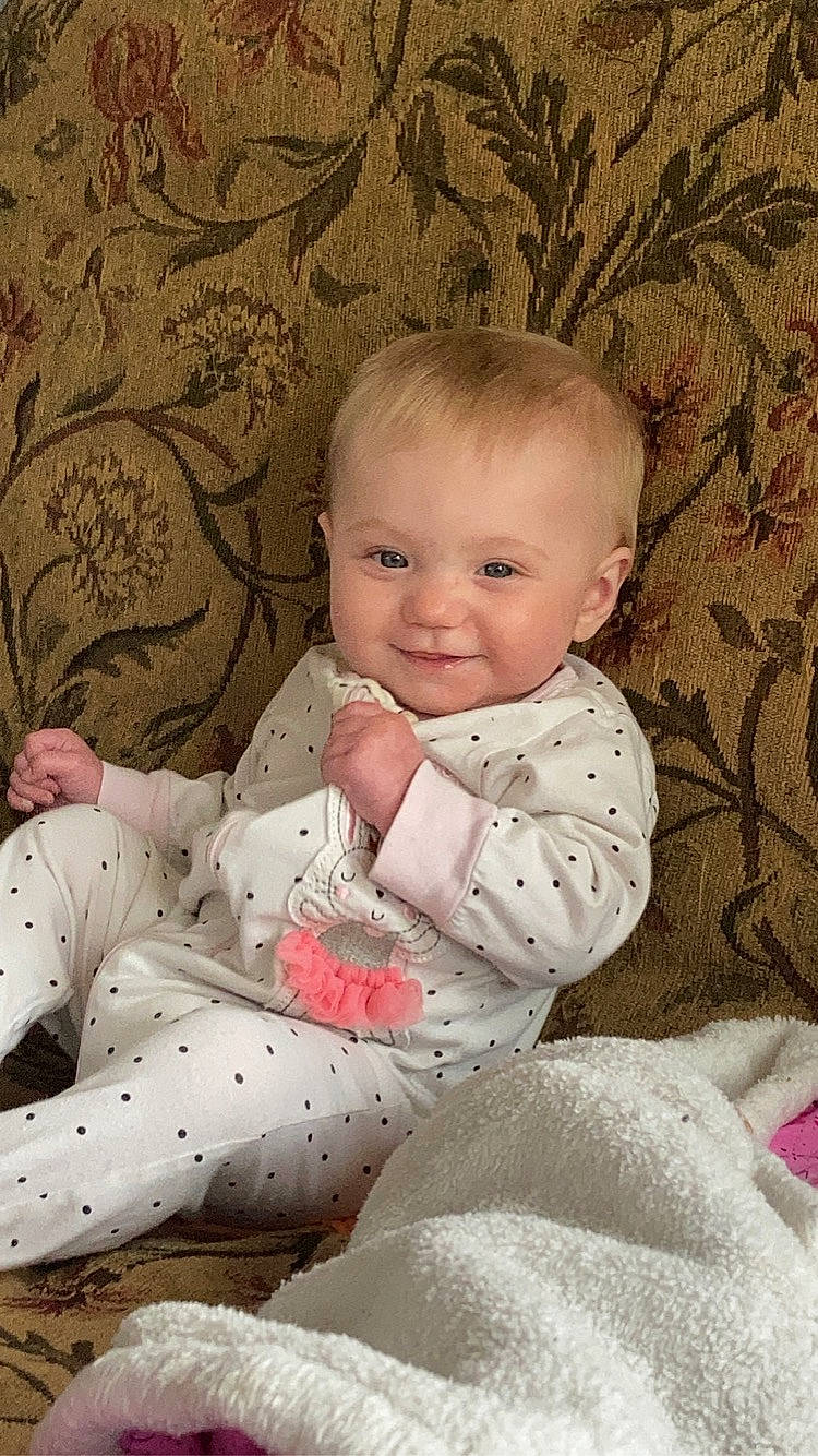 Alexis is registered to the contest to win money with this photo: art, baby, baby_toddler_clothing, carmine, cheek, child, comfort, face, happy, human_body, iris, joy, linens, pattern, person, sitting, skin, sleeve, smile, textile