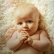 Mya is registered to the contest to win money with this photo: baby, infant, child, face, hands, skin, fluffy_blanket, lying_down, cute, portrait, expression, curious, closeup, naked_torso, soft_texture, young, newborn, indoors, peaceful, adorable
