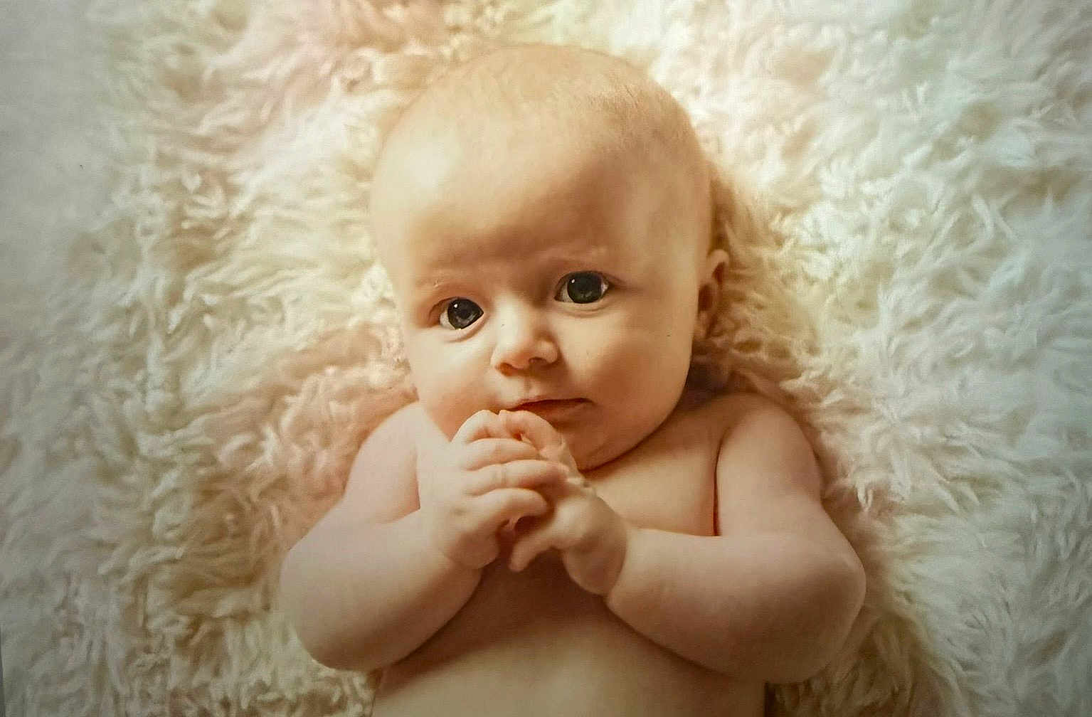 Mya is registered to the contest to win money with this photo: baby, infant, child, face, hands, skin, fluffy_blanket, lying_down, cute, portrait, expression, curious, closeup, naked_torso, soft_texture, young, newborn, indoors, peaceful, adorable