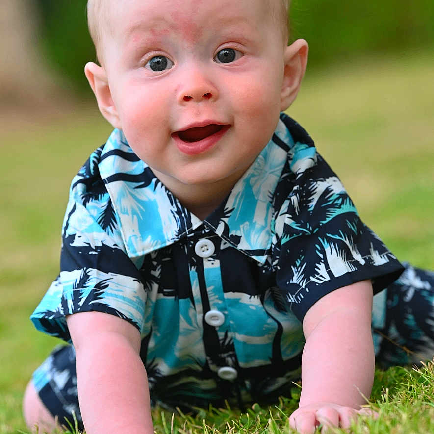 Oliver is registered to the contest to win money with this photo: baby, blue_shirt, child, crawling, cute, face, grass, greenery, happy, infant, nature, outdoor, patterned_clothing, playful, portrait, short_hair, skin, smiling, summer, young_child