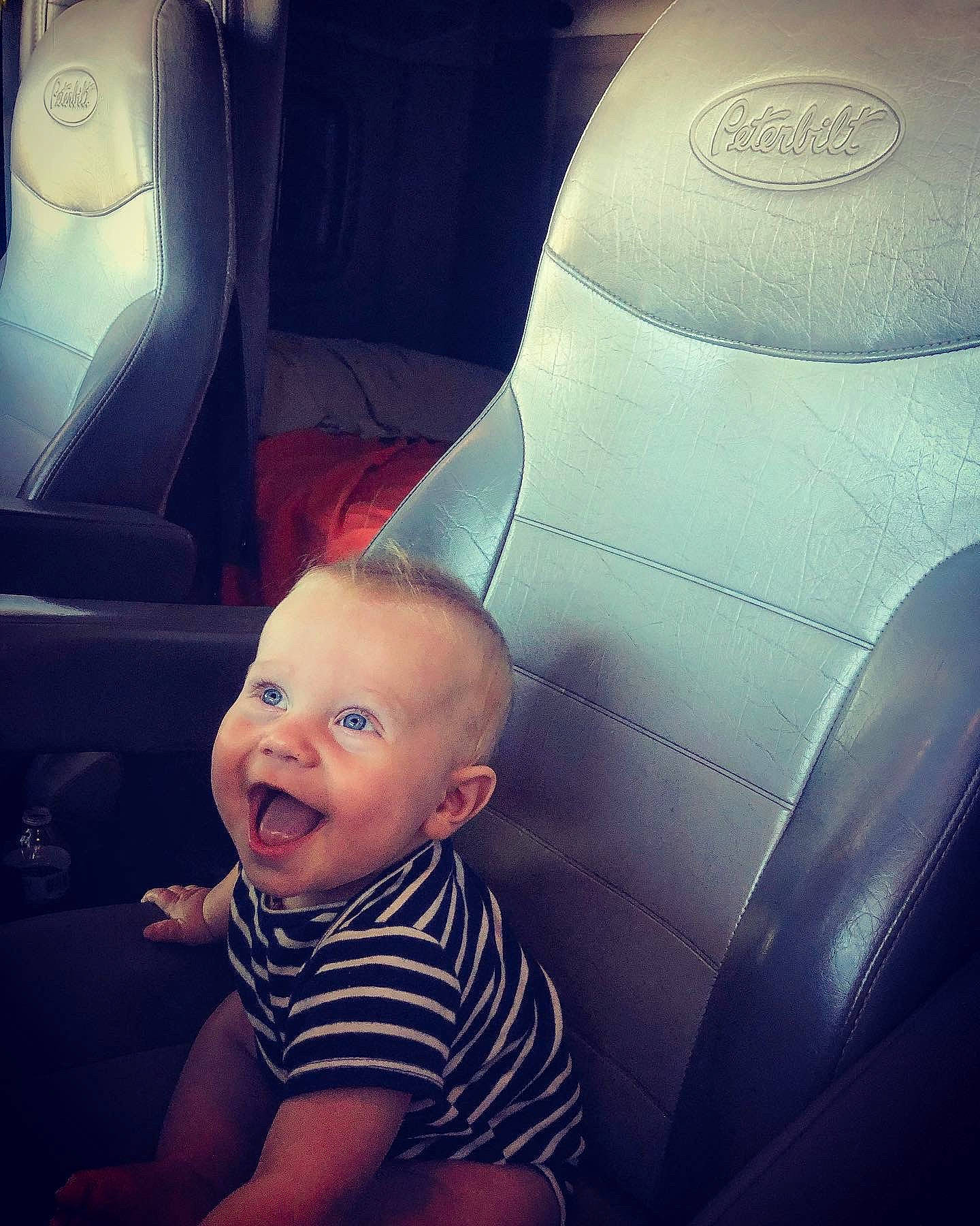 Karsyn is registered to the contest to win money with this photo: baby, car, car_seat, child, cloud, cool, eye, leg, meteorological_phenomenon, mouth, nose, person, plant, sitting, skin, sky, space, technology, toddler, vacation