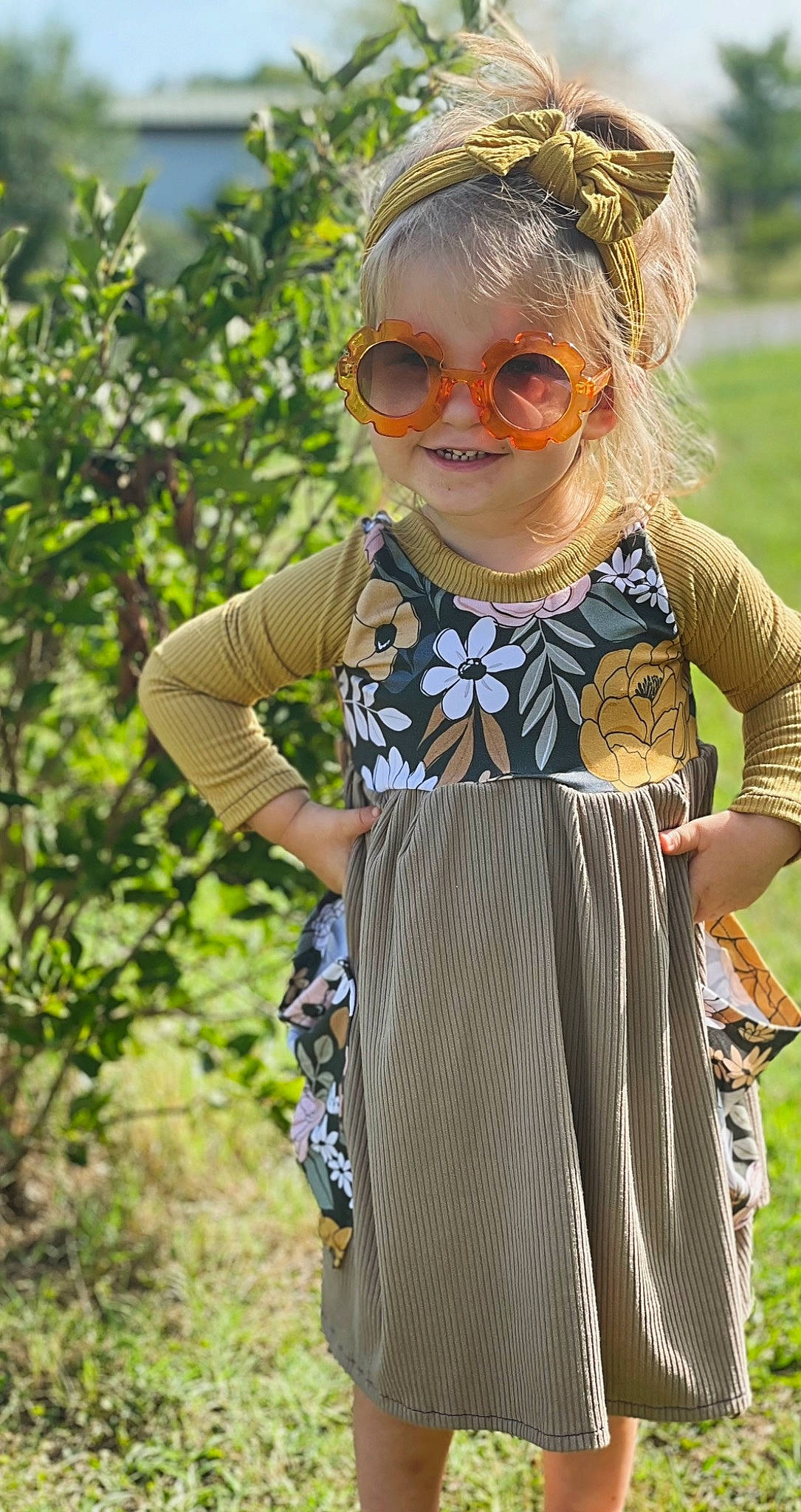Meredith is registered to the contest to win money with this photo: arm, day_dress, dress, eyewear, fawn, glasses, goggles, grass, hairstyle, happy, joy, leaf, outerwear, people_in_nature, person, plant, sleeve, smile, street_fashion, sunglasses