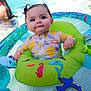 baby, child, pool, water, inflatable_ring, swimming, summer, cute, pigtails, outdoor, toy, colorful, happy, floating, splash, sunlight, play, toddler, person, fun