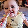 baby, child, infant, yellow_clothing, winnie_the_pooh, piglet, hairbrush, pigtails, smiling, indoors, cute, playful, person, sitting, face, eyes, hand, chewing, bed, toy