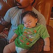 Kaiya is registered to the contest to win money with this photo: arm, baby, casual, child, comfort, couch, curly_hair, diaper, facial_hair, green_tshirt, home, indoor, leather, man, peaceful, person, relaxing, seated, sleeping, tattoo