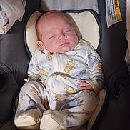 Hunter is registered to the contest to win money with this photo: newborn, baby, sleeping, onesie, cartoon_prints, car_seat, cushion, blanket, infant, cute, peaceful, indoors, child, soft, resting, sleep, person, wearing, footed_pajamas, head