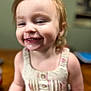 toddler, child, smiling, drool, dress, buttoned, indoor, blurry_background, happy, face, person, cute, messy_hair, skin, young_child, portrait, infant, baby, closeup, warm_lighting
