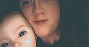 Paislee joined the competition — help win amazing prizes! baby, infant, adult, parent, cuddling, selfie, portrait, face, smiling, surprised, eyes, indoors, close_up, family, caregiving, bare_shoulders, dark_background, photography, human, affection