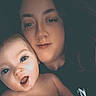 baby, infant, adult, parent, cuddling, selfie, portrait, face, smiling, surprised, eyes, indoors, close_up, family, caregiving, bare_shoulders, dark_background, photography, human, affection