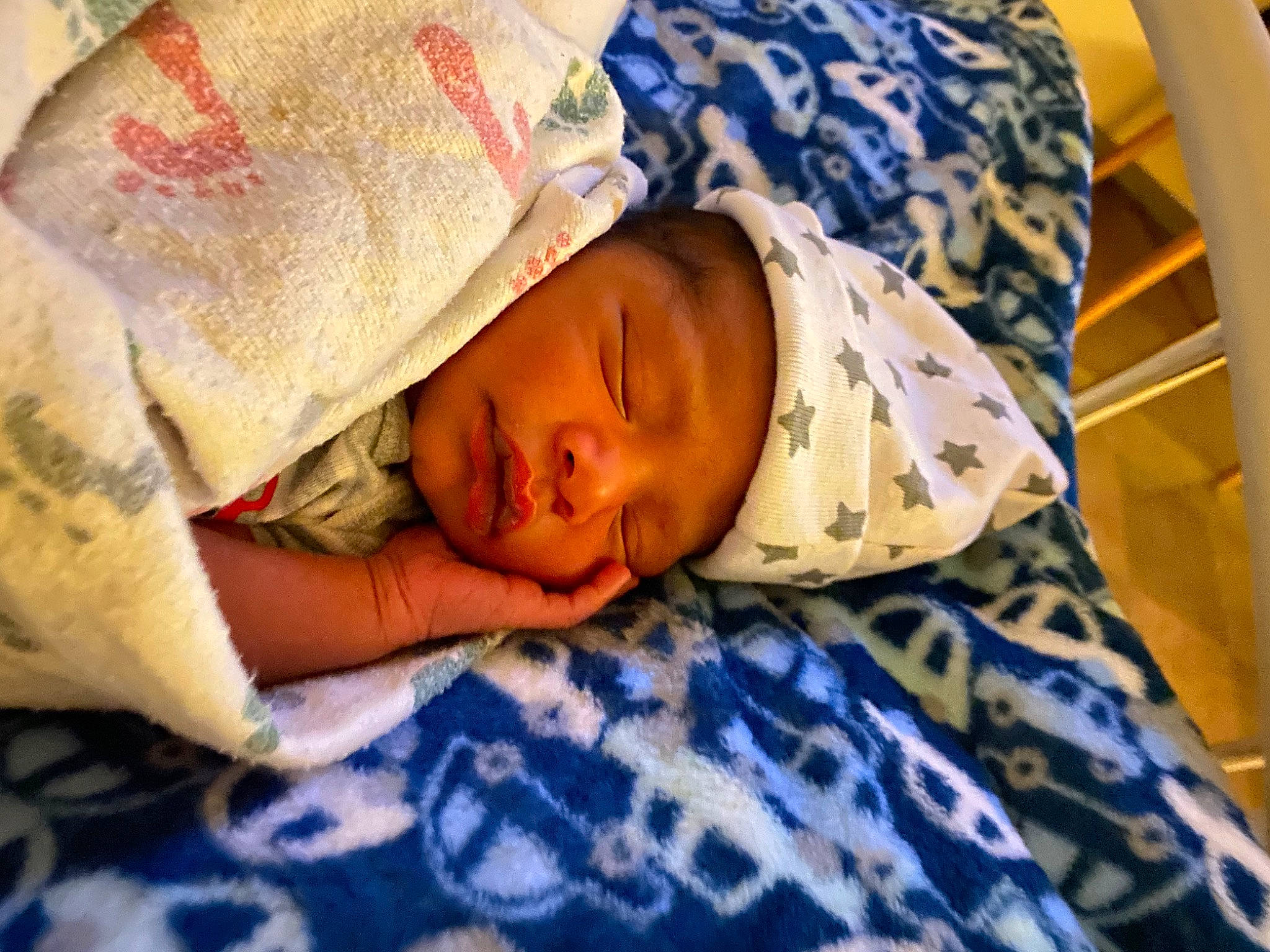 Caleb is registered to the contest to win money with this photo: abdomen, arm, baby, baby_products, baby_sleeping, bedding, bedroom, bedtime, comfort, couch, eye, face, hand, head, headwear, human_body, linens, nap, pattern, person