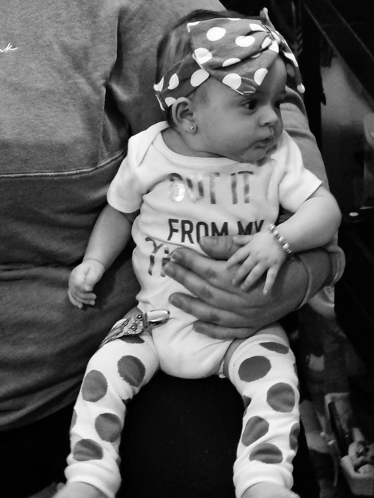 Nevaeh is registered to the contest to win money with this photo: baby, baby_carriage, baby_products, baby_toddler_clothing, black, black_and_white, child, happy, headwear, leg, monochrome, monochrome_photography, pattern, person, personal_protective_equipment, photograph, sitting, skin, sleeve, style