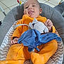 Augustin participe au concours pour gagner de l'argent avec cette photo : baby, infant, orange_onesie, plush_toy, elephant_toy, baby_seat, chevron_pattern, tiled_floor, tongue_out, happy, child, indoor, cushion, toy, playful, person, smile, cute, comfort, home