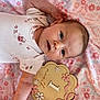 Alayna Kate joined the competition — help win amazing prizes! baby, newborn, infant, onesie, blanket, floral_pattern, pink, wooden_plaque, milestone, portrait, closeup, eyes_open, hand, arm, bedding, cute, rosy_cheeks, head, nursery, smile