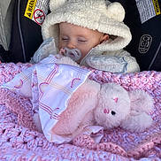 Alayna Kate is registered to the contest to win money with this photo: apparel, baby, blanket, car_seat, child, comfort, cozy, crocheted_blanket, cute, face, hooded_jacket, indoors, infant, pacifier, pink, plush_toy, resting, sleeping, soft_toy, white