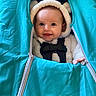 baby, baby_gear, bear_ears, bundle, child, clothing, cozy, cute, face, happy, hood, indoor, infant, person, portrait, sleeping_bag, smile, turquoise, warm, zipper