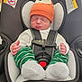 baby, infant, car_seat, hat, orange_hat, green_pants, striped_pants, white_socks, sleeping, child, seatbelt, safety, cute, newborn, indoors, closeup, person, resting, headwear, car