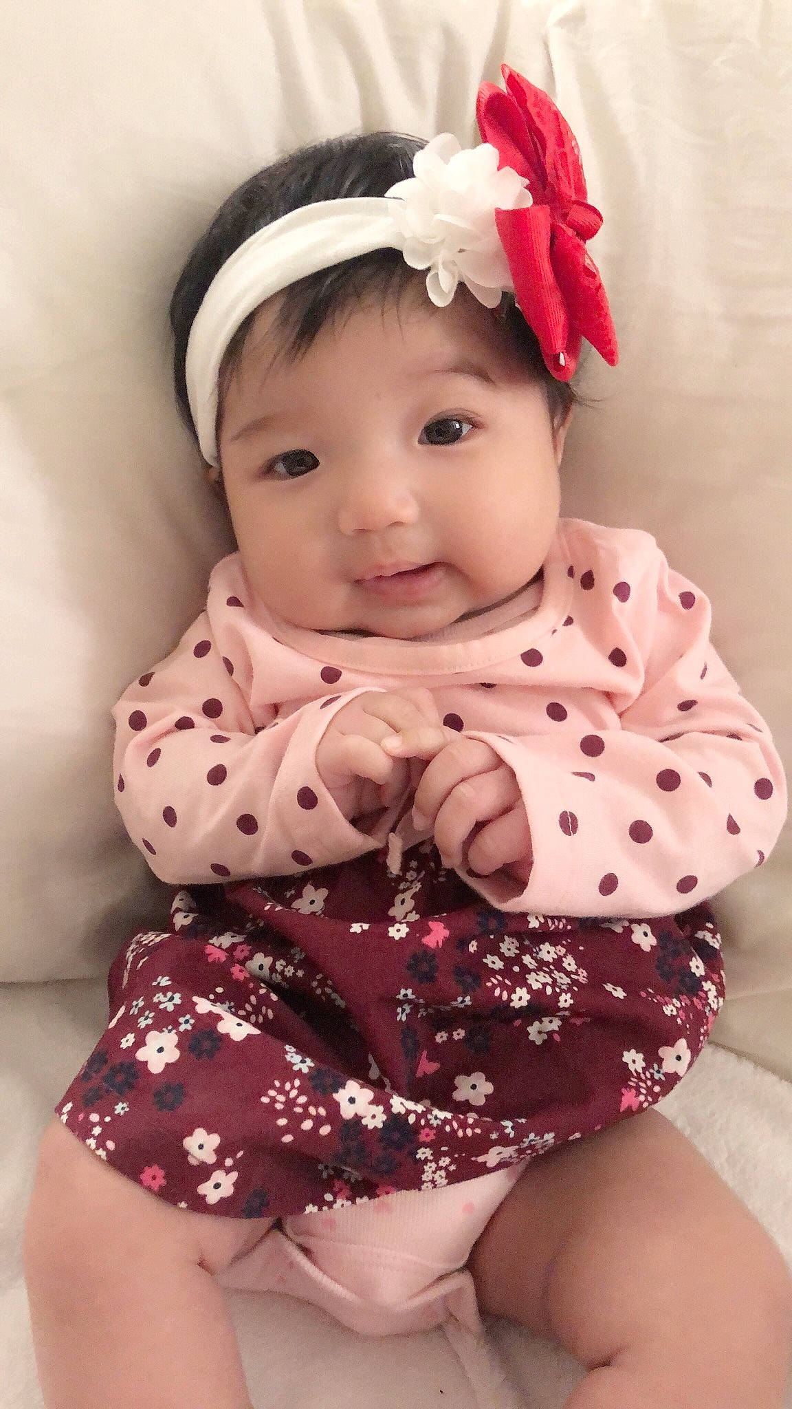 Isabella is registered to the contest to win money with this photo: baby, baby_bloomers, baby_products, baby_toddler_clothing, cheek, child, child_model, design, fashion_accessory, hair_accessory, head, headband, headgear, pattern, person, pink, polka_dot, product, sleeve, smile