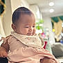 Celina joined the competition — help win amazing prizes! baby, child, infant, smiling, indoors, dress, bib, soft_lighting, blurred_background, curtains, furniture, couch, person, cute, happy, chubby_cheeks, portrait, sitting, skin, head