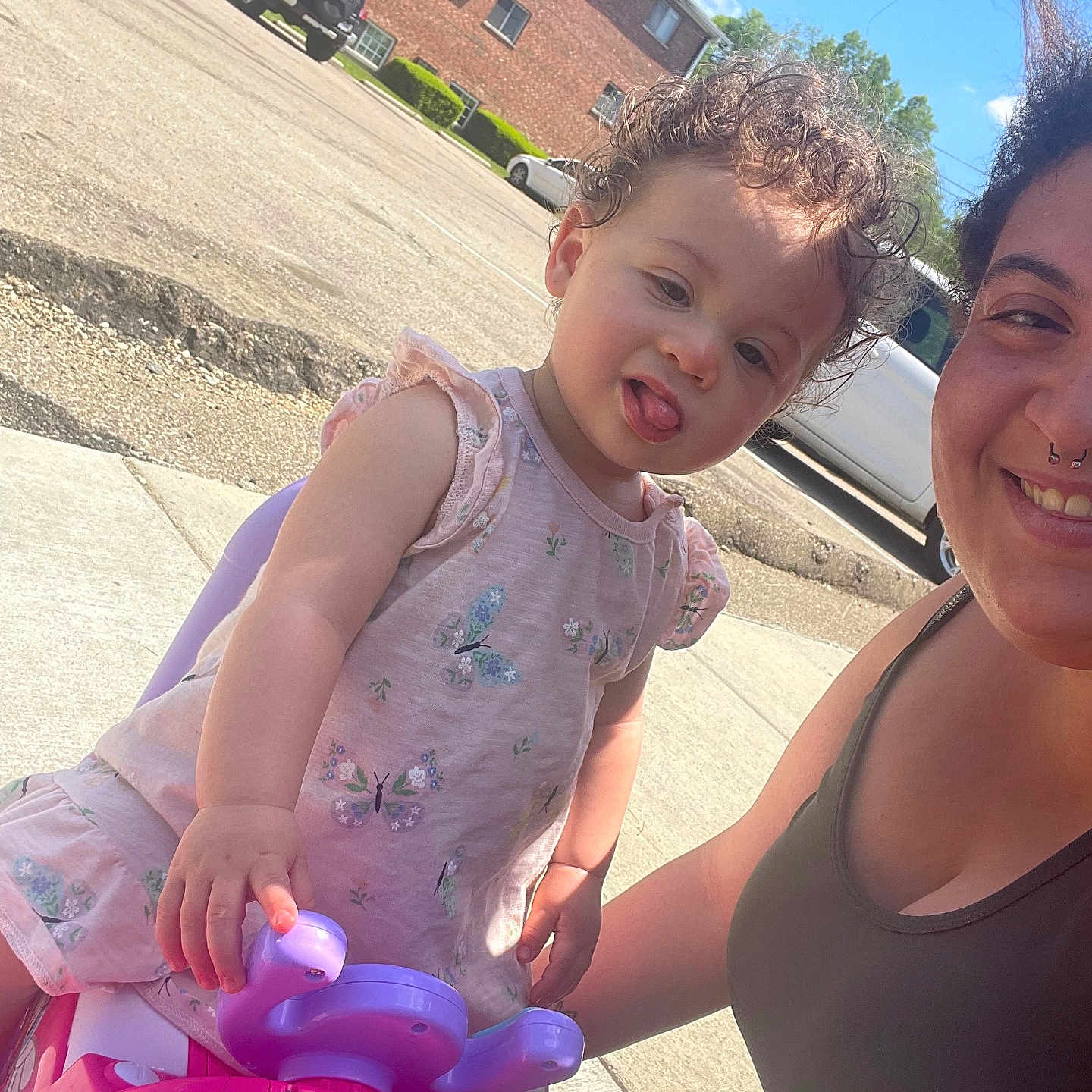 Maliah joined the competition — help win amazing prizes! baby, car, city, clothing, dress, face, head, machine, outdoors, person, photography, portrait, purple, road, street, summer, transportation, urban, vehicle, wheel