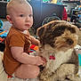 baby, child, dog, pet, indoor, living_room, toy, play_mat, curtains, furniture, carpet, onesie, floor, person, animal, friendship, candid, soft_lighting, cute, toddler