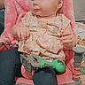 Salem is registered to the contest to win money with this photo: baby, child, infant, sitting, activity_chair, pink_chair, toy, green_toy, floral_outfit, smiling, face, portrait, indoor, home, door, clothing, blanket, furniture, family_photo, candid