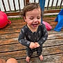 Evan joined the competition — help win amazing prizes! toddler, child, laughing, outdoor, deck, wooden_floor, playground, toy, red_ball, blue_slide, pajamas, curly_hair, barefoot, happy, smiling, person, wooden_railings, daylight, fun, cactus_pattern