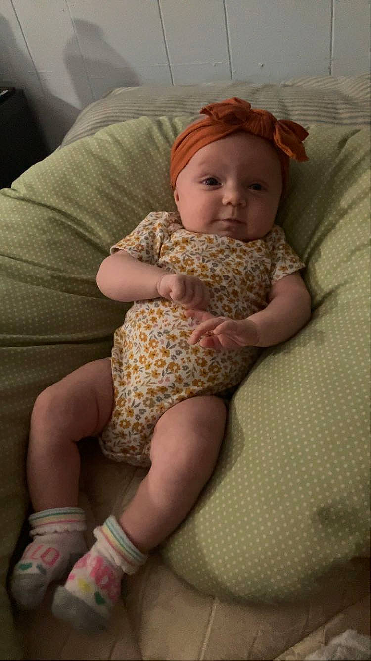 Alayah is registered to the contest to win money with this photo: baby, baby_toddler_clothing, comfort, couch, eye, finger, head, headwear, human_body, iris, joint, knee, lap, leg, neck, person, shoulder, skin, stomach, thigh