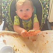 Zayden joined the competition — help win amazing prizes! baby, child, cute, expression, face, floor, food, fork, green_shirt, hair, hands, high_chair, indoor, kitchen, meal_time, messy, plastic_tray, seat, spaghetti, toddler
