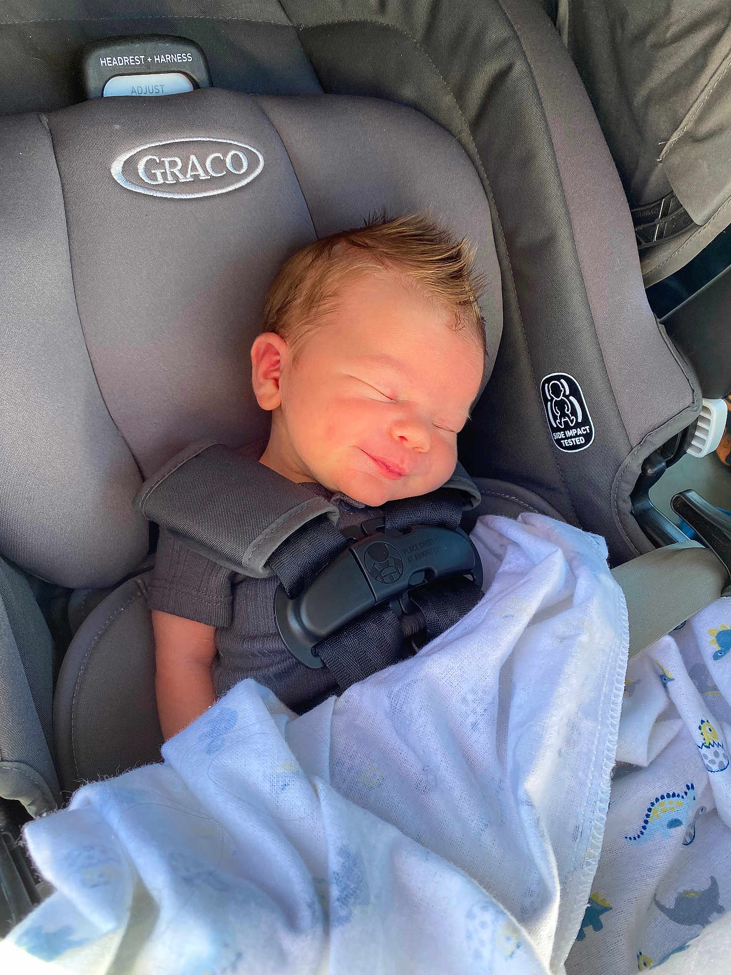 Zayden is registered to the contest to win money with this photo: baby, blanket, car, car_interior, carseat, clothing, cushion, face, glove, head, headrest, homedecor, newborn, person, photography, portrait, sleeping, t_shirt, transportation, vehicle