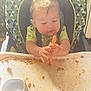Zayden joined the competition — help win amazing prizes! baby, child, clothing, curious, eating, face, floor, food, hands, high_chair, indoor, kitchen, meal, messy, plate, seat, spaghetti, spoon, table, toddler