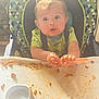 Zayden is registered to the contest to win money with this photo: baby, child, curly_hair, cute, eating, food, food_mess, green_shirt, high_chair, indoor, kitchen, meal, messy, person, plastic_tray, plate, sauce, spaghetti, toddler, utensil