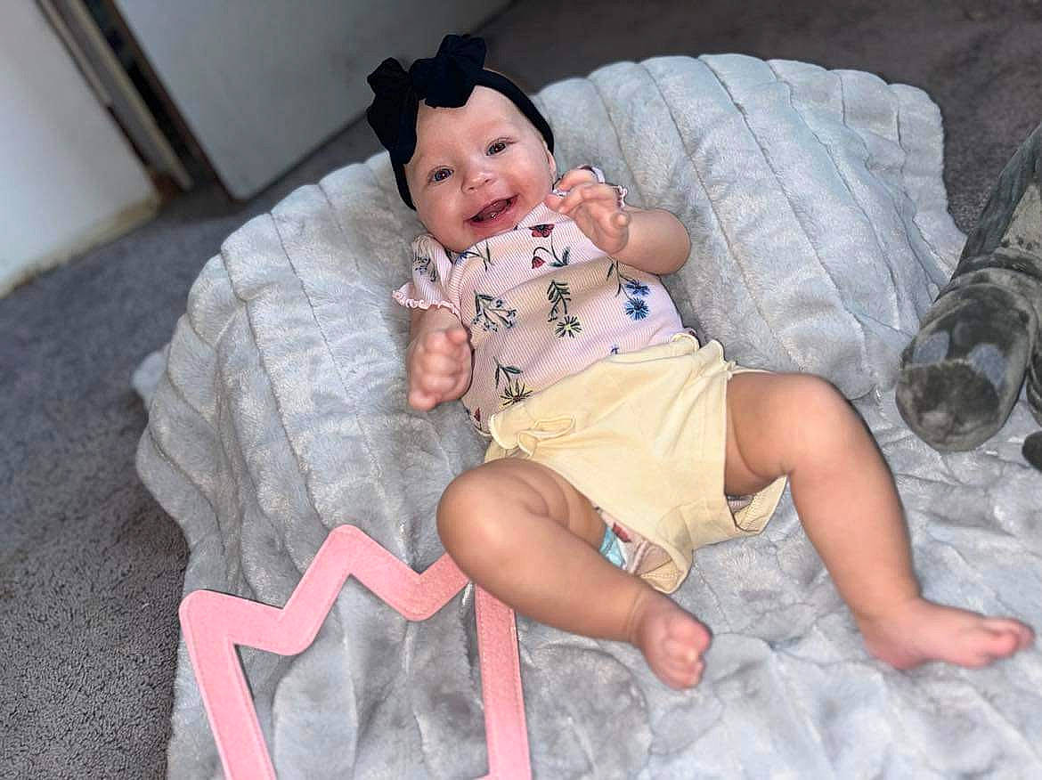 Ivory is registered to the contest to win money with this photo: baby, baby_toddler_clothing, cheek, child, comfort, eye, face, foot, fun, head, headwear, human_body, human_leg, iris, knee, lap, mouth, person, skin, thigh