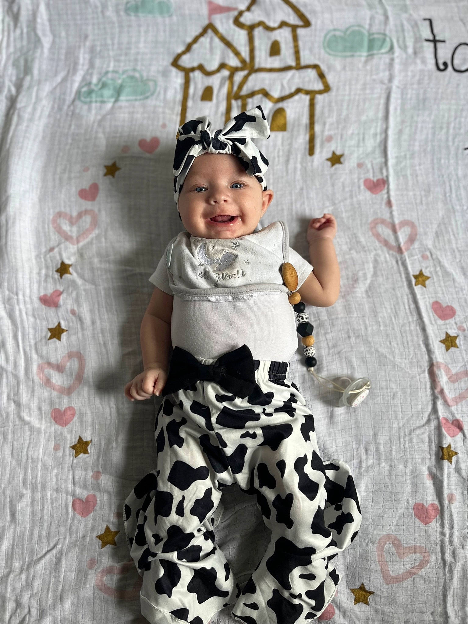 Ivory is registered to the contest to win money with this photo: baby, baby_toddler_clothing, cap, child, costume_hat, dress, face, fashion_design, happy, headwear, linens, magenta, one_piece_garment, pattern, person, pink, product, sleeve, smile, t_shirt