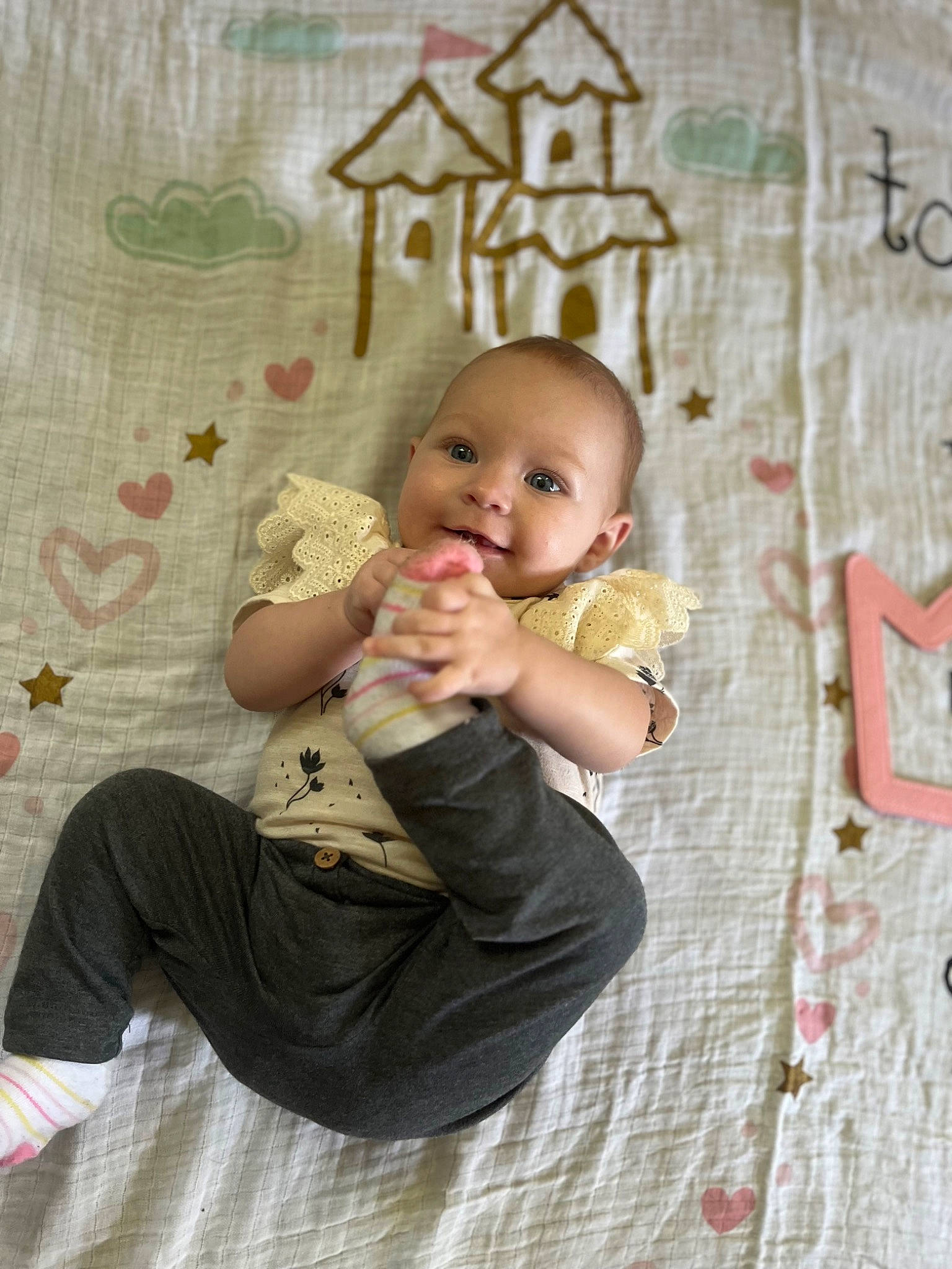 Ivory is registered to the contest to win money with this photo: baby, baby_toddler_clothing, cheek, child, finger, flash_photography, flooring, foot, fun, gesture, grass, happy, joy, pattern, people_in_nature, person, pink, play, sitting, skin