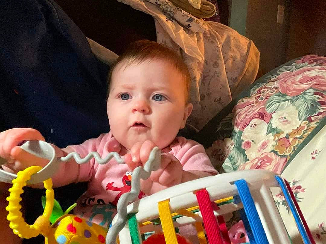 Kyrie is registered to the contest to win money with this photo: baby, baby_products, baby_toddler_clothing, baby_toys, cheek, child, event, eye, face, fun, happy, head, iris, linens, person, play, product, room, sitting, toddler