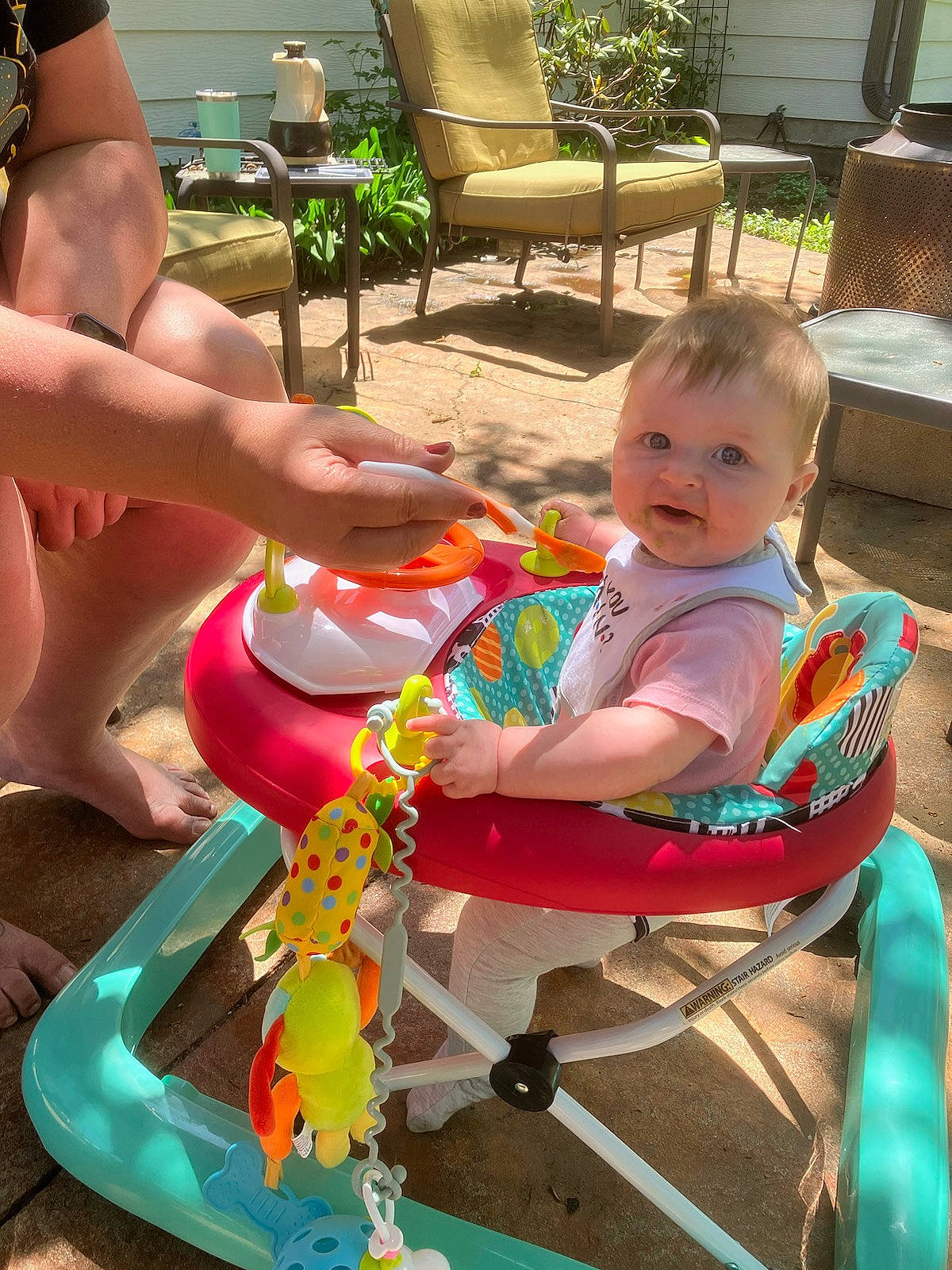 Kyrie is registered to the contest to win money with this photo: baby, baby_toddler_clothing, chair, child, comfort, fun, green, happy, houseplant, human_leg, lap, leisure, outdoor_furniture, person, plant, sharing, sitting, smile, summer, thigh