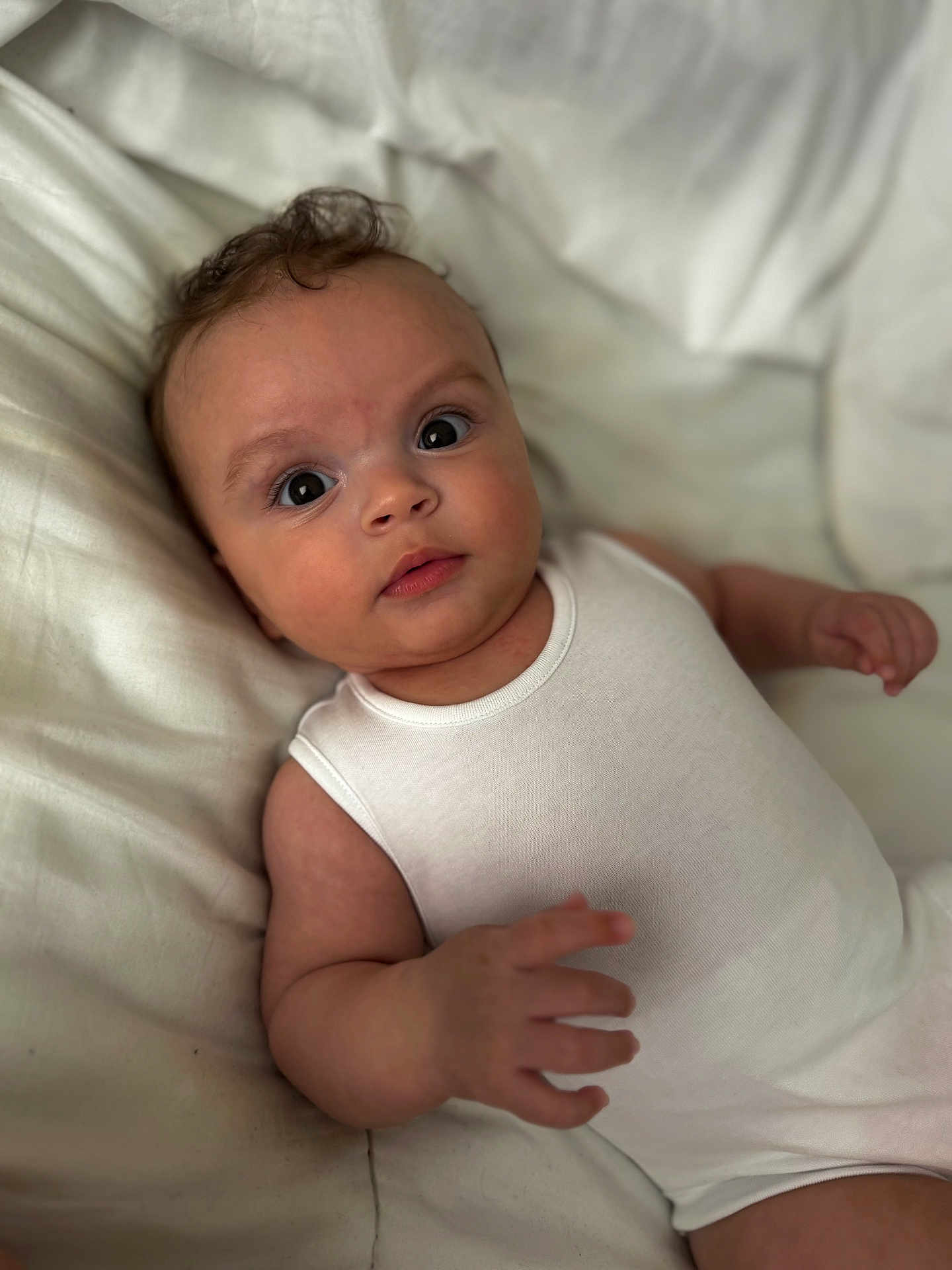 Tyde joined the competition — help win amazing prizes! baby, child, curious_look, cute, expression, eyes, face, hand, head, human, indoor, infant, lying_down, newborn, onesie, portrait, skin, small_fingers, soft_blanket, white_clothing