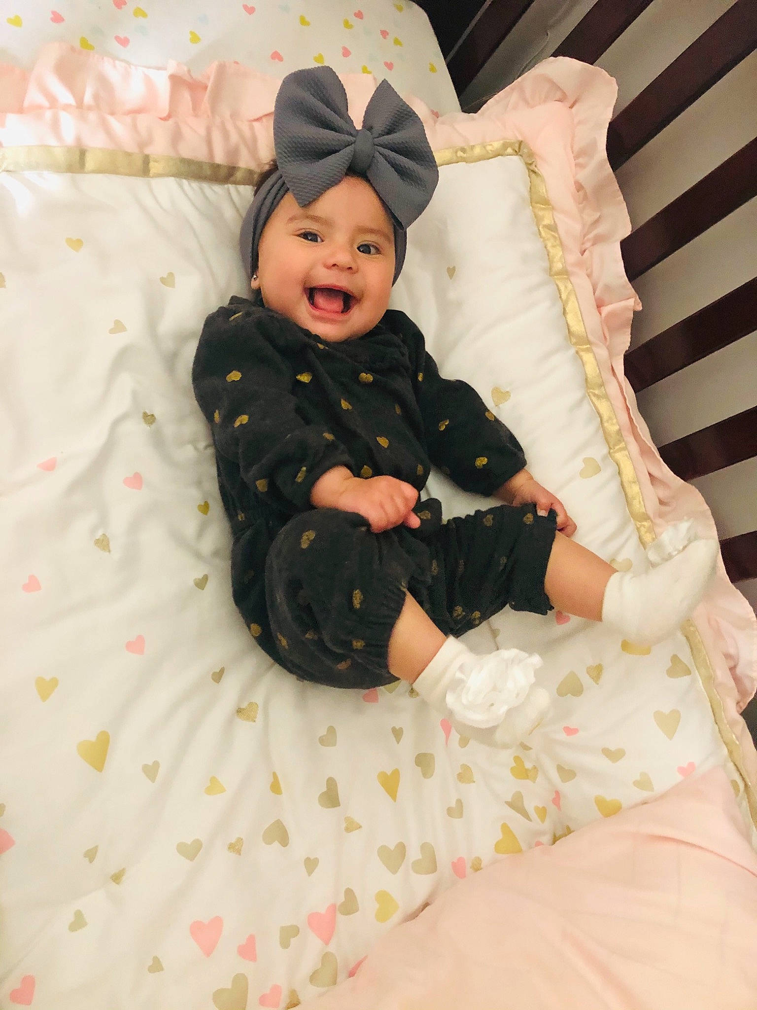 Victoria joined the competition — help win amazing prizes! baby, baby_products, baby_safety, baby_toddler_clothing, bedding, cap, child, comfort, face, headwear, lap, linens, pattern, person, pink, room, sitting, skin, sleeve, smile