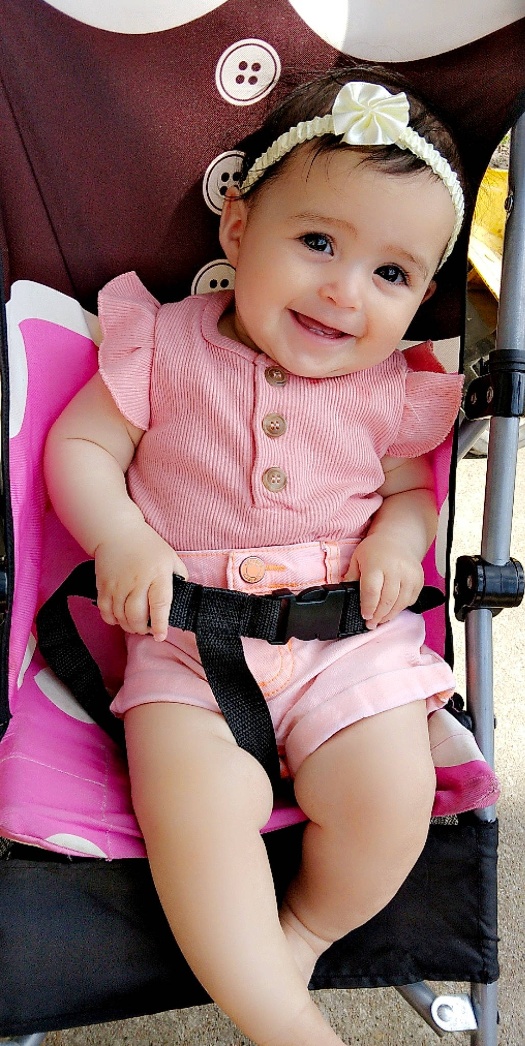 Adalie is registered to the contest to win money with this photo: baby, baby_carriage, baby_toddler_clothing, cheek, clothing, eye, eyelash, finger, happy, head, headwear, iris, joy, knee, lip, magenta, person, pink, shorts, skin