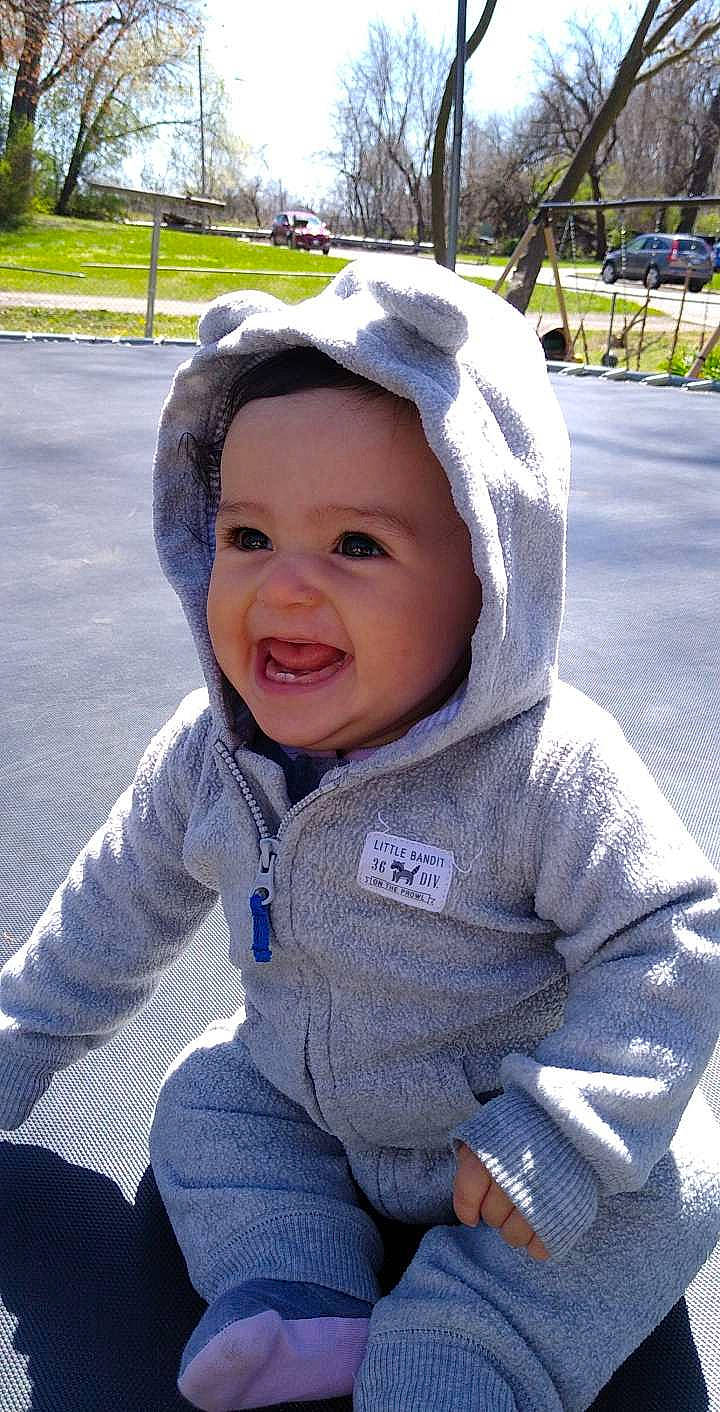 Adalie is registered to the contest to win money with this photo: baby, baby_toddler_clothing, cap, cheek, child, electric_blue, fun, grass, happy, headwear, leisure, outerwear, person, plant, purple, recreation, sitting, sleeve, smile, toddler