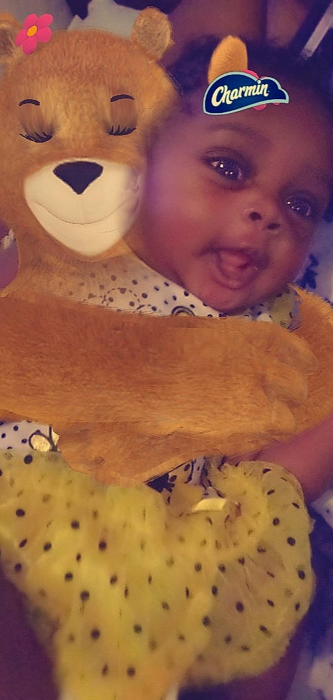 Zai'Da is registered to the contest to win money with this photo: baby, baseball_cap, child, cuisine, dish, facial_expression, food, happy, head, ingredient, junk_food, nose, organ, person, recipe, skin, smile, toddler, toy, white