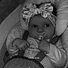 baby, black_and_white, bow, car_seat, child, closeup, clothing, cushion, cute, elephant, expression, face, hands, headband, indoors, infant, pacifier, portrait, seatbelt, soft_toy