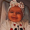 Daiana a rejoint le concours — aidez-le/la à gagner de superbes lots ! apparel, baby, child, clothing, cozy, cute, expression, face, hand, happy, headband, headwear, indoor, infant, mickey_mouse, person, portrait, smiling, sweater, young_child