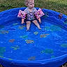 toddler, pool, floaties, water, grass, outdoor, child, blue, toy, summer, car, sitting, serious, clothing, play, sunlight, nature, plastic, recreation, backyard