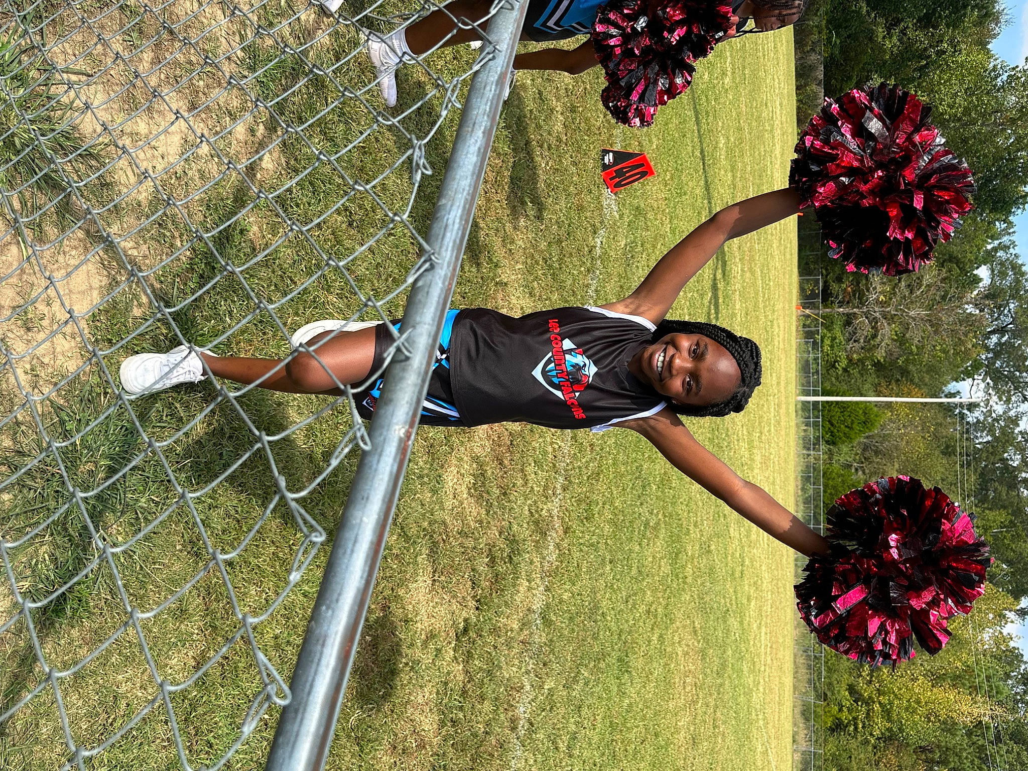 Prisparite is registered to the contest to win money with this photo: cheerleading, cheerleading_uniform, event, fence, flower, grass, joy, leisure, mesh, net, performing_arts, person, plant, pole, rope, sky, sports, sports_uniform, team_sport, tree