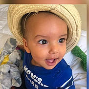 Alloux Nhesta a rejoint le concours — aidez-le/la à gagner de superbes lots ! bed, blue_shirt, child, clothing, cushion, cute, expression, face, happy, hat, indoor, person, playful, plush, portrait, smiling, soft_toys, straw_hat, toddler, young_child