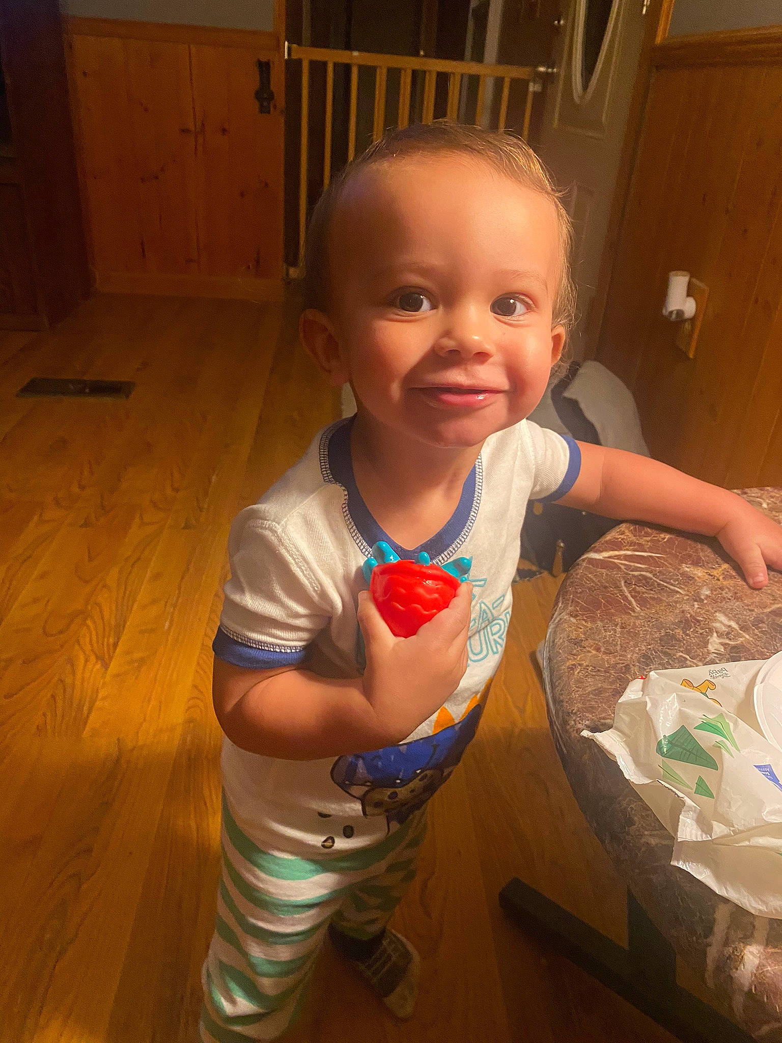 Zane is registered to the contest to win money with this photo: baby, baby_toddler_clothing, cheek, child, eye, finger, floor, flooring, fun, happy, hardwood, iris, joy, mouth, nose, person, skin, smile, t_shirt, thumb