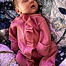 baby, newborn, sleeping, pink_clothing, quilt, blanket, patterned, infant, cozy, cute, soft, child, portrait, resting, indoors, fabric, textile, warm, peaceful, relaxed