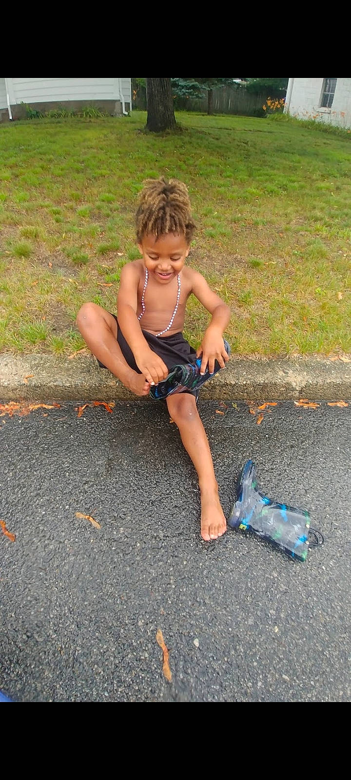 Jamal joined the competition — help win amazing prizes! asphalt, barefoot, child, foot, fun, grass, hair, human_body, human_leg, leg, leisure, people_in_nature, person, recreation, road_surface, shorts, sidewalk, thigh, toddler, toy