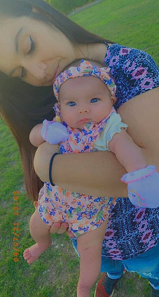 Serenity Marie is registered to the contest to win money with this photo: abdomen, baby, baby_toddler_clothing, face, fun, grass, happy, headwear, human_body, leisure, meadow, organ, person, pink, plant, product, skin, smile, summer, thigh